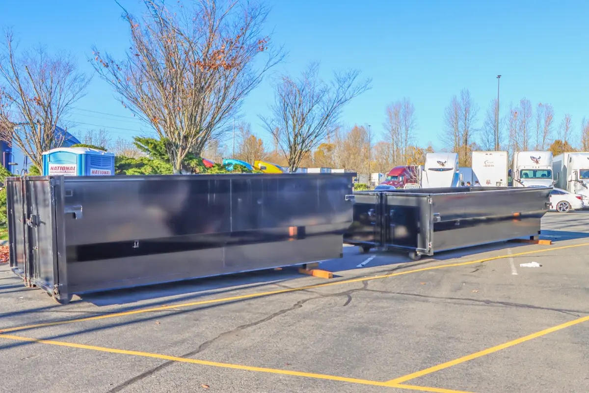 Professional dumpster rental service with roll-off container on residential driveway in Uniontown